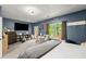 Spacious bedroom with blue walls, carpet floors, and a large window offering plenty of natural light at 1647 Tunbridge Ln, Lawrenceville, GA 30043