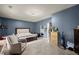 Bedroom with a comfortable chair, a view to another room, and great natural light at 1647 Tunbridge Ln, Lawrenceville, GA 30043