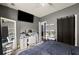Bedroom featuring dark walls, desk with makeup mirror, television, and a dark bedspread at 1647 Tunbridge Ln, Lawrenceville, GA 30043