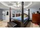 Main bedroom featuring a four poster bed, ceiling fan and tile floors at 1647 Tunbridge Ln, Lawrenceville, GA 30043
