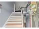 Inviting home entryway with wooden stairs and a view into the living room, illuminated by natural light at 1647 Tunbridge Ln, Lawrenceville, GA 30043