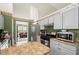 Functional kitchen features stainless appliances, ample countertop space and a breakfast area at 1647 Tunbridge Ln, Lawrenceville, GA 30043