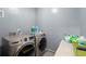 A laundry room showcasing modern, front-loading washer and dryer units at 1647 Tunbridge Ln, Lawrenceville, GA 30043