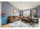 Spacious living room boasts neutral decor, a large window, and an elegant chandelier at 1647 Tunbridge Ln, Lawrenceville, GA 30043