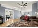 Cozy living room with ceiling fan, fireplace, and open access to the dining and kitchen areas at 1647 Tunbridge Ln, Lawrenceville, GA 30043