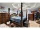 Well-lit main bedroom featuring a four-post bed and neutral colors at 1647 Tunbridge Ln, Lawrenceville, GA 30043