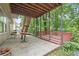 Covered patio area with outdoor seating and backyard access at 1647 Tunbridge Ln, Lawrenceville, GA 30043
