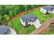 Stunning aerial view of a two-story home featuring a landscaped yard and a two-car garage with a paved driveway at 165 Westbrook St, Buford, GA 30518