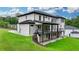 Exterior view of the house featuring a covered deck, patio, and beautiful lawn at 165 Westbrook St, Buford, GA 30518