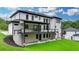 Exterior view of the house, featuring a covered deck, walkout basement, and landscaped backyard at 165 Westbrook St, Buford, GA 30518