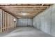 Unfinished basement featuring exposed ceiling, concrete walls and flooring, and a small window at 165 Westbrook St, Buford, GA 30518