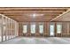 Unfinished basement featuring wood framing, windows, and a door, ready for customization at 165 Westbrook St, Buford, GA 30518
