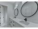 This spacious bathroom features double sinks, modern fixtures, and marble tile floors at 165 Westbrook St, Buford, GA 30518