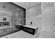 Luxurious bathroom with modern black freestanding tub, marble tile surround, and frameless shower with sleek fixtures at 165 Westbrook St, Buford, GA 30518
