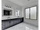 Bright bathroom featuring marble countertops, dual sinks, modern fixtures, and natural light at 165 Westbrook St, Buford, GA 30518