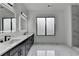 Bathroom featuring a double vanity, marble countertops, modern fixtures, and a large window at 165 Westbrook St, Buford, GA 30518