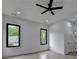 Bedroom featuring light hardwood floors, ceiling fan, recessed lights, and two windows at 165 Westbrook St, Buford, GA 30518