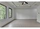 This bedroom features large windows, recessed lighting and a ceiling fan at 165 Westbrook St, Buford, GA 30518