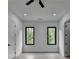 Spacious bedroom featuring recessed lighting, neutral paint, wide plank flooring, and tree views from the windows at 165 Westbrook St, Buford, GA 30518