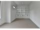 A well-lit bedroom showcases stylish wood-look floors and built-in shelving and cabinets at 165 Westbrook St, Buford, GA 30518