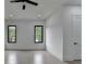 Brightly lit bedroom with wood-look flooring and views to the outdoors through black-framed windows at 165 Westbrook St, Buford, GA 30518