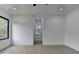 This bedroom offers neutral walls, light floors, and an open view to the en suite bathroom at 165 Westbrook St, Buford, GA 30518