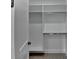 Walk-in closet with custom shelving and racks for optimal organization and storage at 165 Westbrook St, Buford, GA 30518