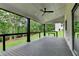 Covered deck with ceiling fan, overlooking a lush green backyard, perfect for outdoor relaxation at 165 Westbrook St, Buford, GA 30518