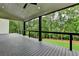 The spacious, covered deck features black railings and offers a serene view of the surrounding trees at 165 Westbrook St, Buford, GA 30518