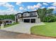 Modern two-story home with a multi-car garage, wide driveway, and landscaped front yard at 165 Westbrook St, Buford, GA 30518
