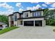 Elegant two-story house with modern design elements, multi-car garage, and a well-maintained lawn at 165 Westbrook St, Buford, GA 30518