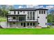 Rear exterior view of modern home with large deck and manicured lawn at 165 Westbrook St, Buford, GA 30518