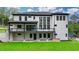 Rear exterior view of modern home with large deck and manicured lawn at 165 Westbrook St, Buford, GA 30518