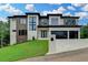 Beautiful two-story home with modern architectural details, a large driveway, and landscaped yard at 165 Westbrook St, Buford, GA 30518