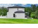 Side exterior of home showing the covered patio, windows, and manicured lawn at 165 Westbrook St, Buford, GA 30518