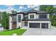 Beautiful two-story home with a modern design, black garage doors, and well-manicured lawn at 165 Westbrook St, Buford, GA 30518