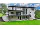 Rear exterior view of modern home with large deck and manicured lawn at 165 Westbrook St, Buford, GA 30518