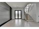 Bright foyer with wood floors, contemporary staircase and frosted double front doors at 165 Westbrook St, Buford, GA 30518