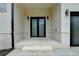 Stylish home entrance featuring a double door and modern lighting at 165 Westbrook St, Buford, GA 30518