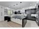 Modern kitchen boasts a large island with marble countertop and sleek black and white cabinetry at 165 Westbrook St, Buford, GA 30518
