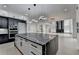 Open-concept kitchen with a large island, pendant lighting, and a modern design at 165 Westbrook St, Buford, GA 30518