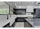 Modern kitchen with black and white cabinets, a large sink, and stainless steel appliances at 165 Westbrook St, Buford, GA 30518