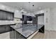 Open-concept kitchen featuring a large island, modern appliances, and stylish pendant lighting at 165 Westbrook St, Buford, GA 30518
