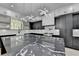 Modern kitchen features a large island, custom cabinetry, and high-end stainless steel appliances, offering both style and functionality at 165 Westbrook St, Buford, GA 30518
