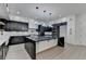 Modern kitchen boasts a large marble island, custom cabinetry, and high-end stainless steel appliances at 165 Westbrook St, Buford, GA 30518