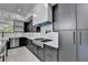 Modern kitchen featuring sleek black and white cabinetry and stainless steel appliances at 165 Westbrook St, Buford, GA 30518