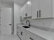 Bright laundry room with stylish cabinetry, quartz countertops, and modern fixtures at 165 Westbrook St, Buford, GA 30518