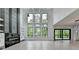 Spacious living room with floor-to-ceiling windows and stylish fireplace at 165 Westbrook St, Buford, GA 30518