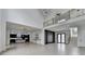 Bright open-concept living room features high ceilings and flows into a modern kitchen with sleek cabinetry at 165 Westbrook St, Buford, GA 30518