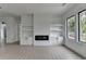 Open-concept living room features modern fireplace with built-in shelving at 165 Westbrook St, Buford, GA 30518